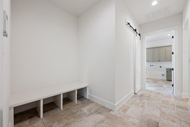 mudroom with a barn door, visible vents, baseboards, and recessed lighting