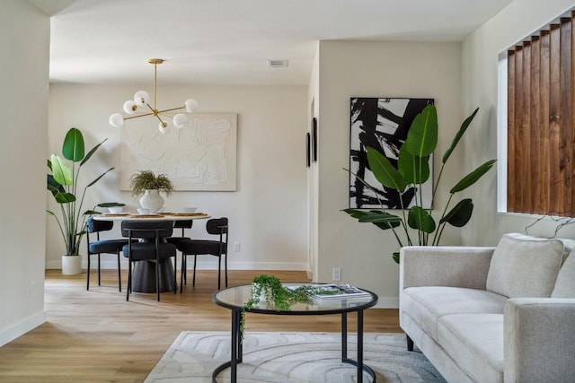 sitting room featuring a chandelier and light wood-type flooring