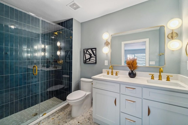 bathroom featuring vanity, toilet, and a shower with door