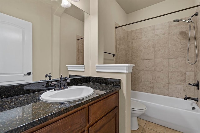 full bathroom with vanity, toilet, tiled shower / bath combo, and tile patterned flooring