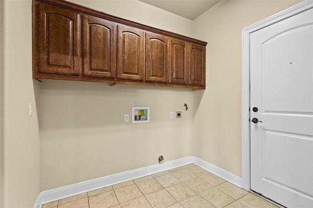 clothes washing area featuring light tile patterned floors, electric dryer hookup, hookup for a washing machine, cabinets, and hookup for a gas dryer