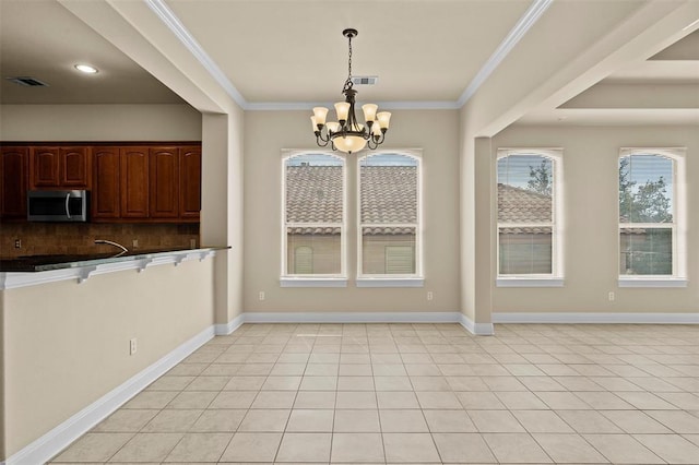 unfurnished dining area with light tile patterned flooring, a notable chandelier, and crown molding