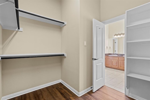 spacious closet with sink and hardwood / wood-style flooring