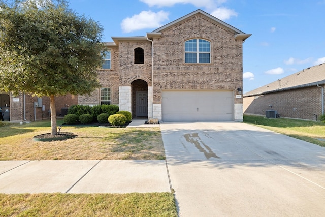 front facade with a garage, a front lawn, and central air condition unit