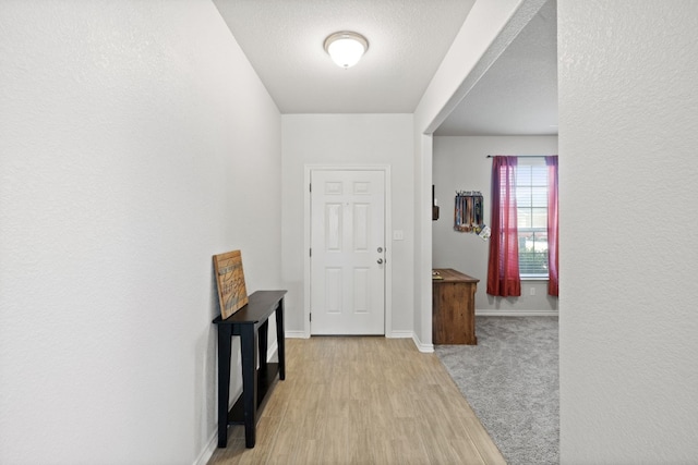 hall with light hardwood / wood-style flooring