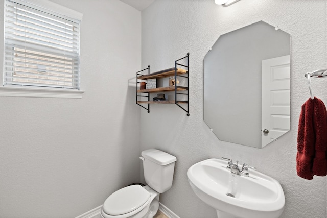 bathroom featuring sink and toilet