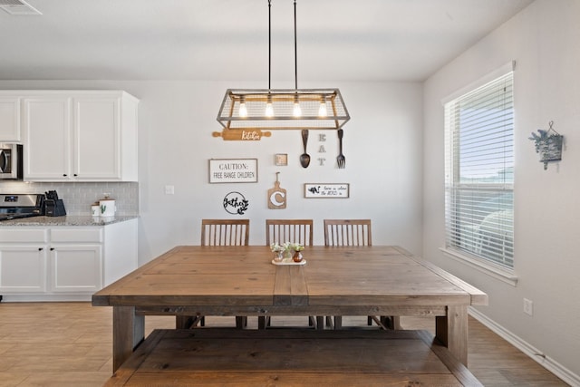 dining area with light wood-type flooring