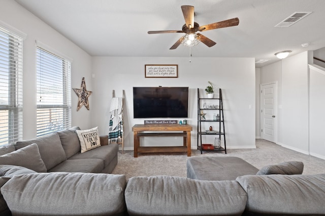 carpeted living room with ceiling fan