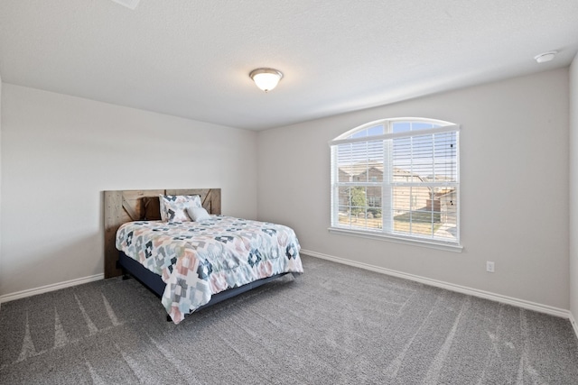 carpeted bedroom featuring a textured ceiling