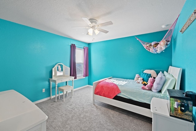 carpeted bedroom featuring ceiling fan and a textured ceiling