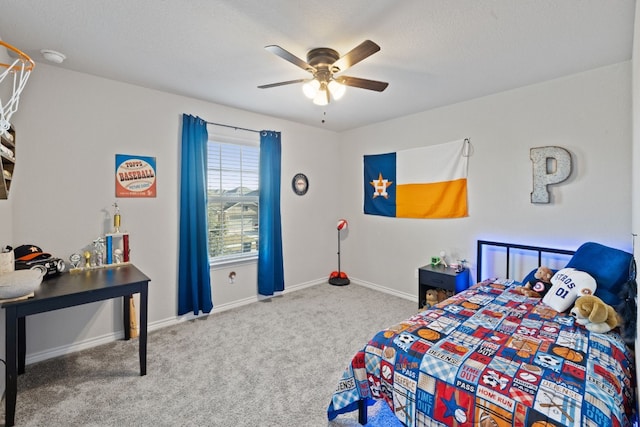 carpeted bedroom with ceiling fan and a textured ceiling