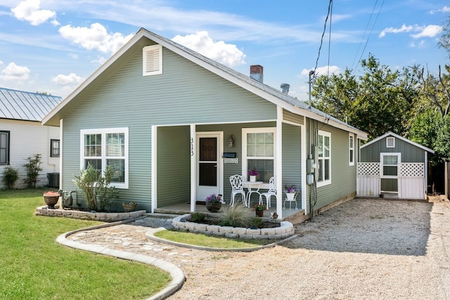 view of front of property with cooling unit, a front yard, and a porch