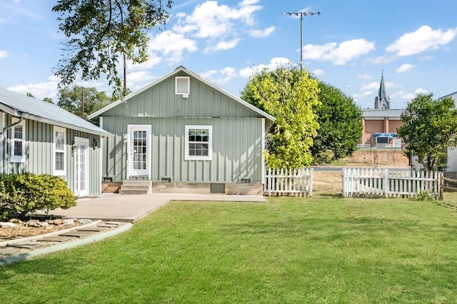 back of property featuring a yard and a patio