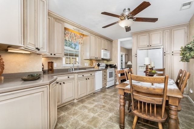 kitchen with sink, white appliances, ceiling fan, tasteful backsplash, and cream cabinetry