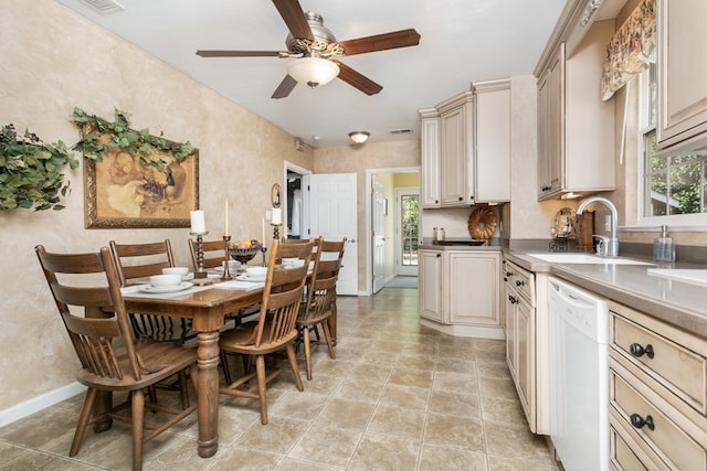 kitchen with dishwasher, sink, light tile patterned floors, ceiling fan, and cream cabinets