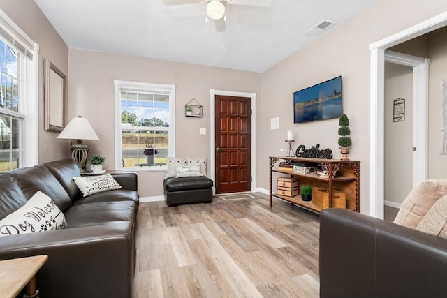 living room with ceiling fan and light hardwood / wood-style flooring