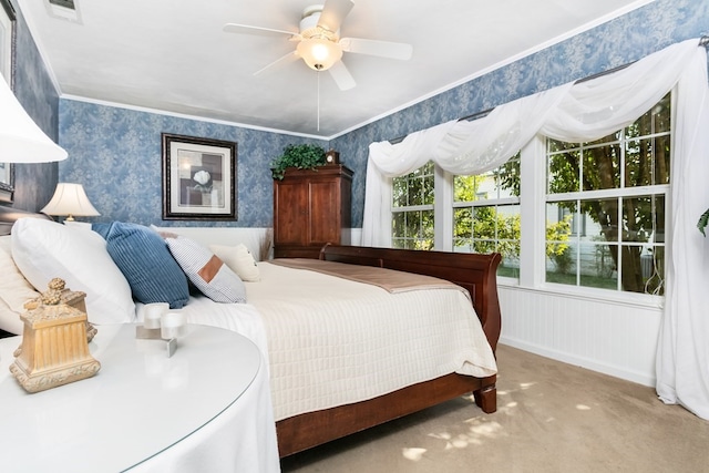 bedroom featuring crown molding, carpet, and ceiling fan