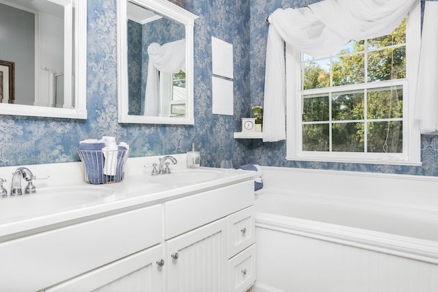 bathroom with vanity and a bath