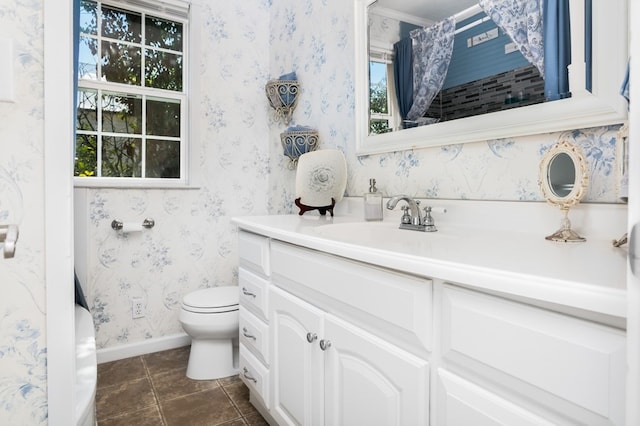 bathroom featuring vanity, tile patterned flooring, and toilet