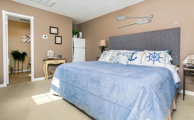 carpeted bedroom with white refrigerator