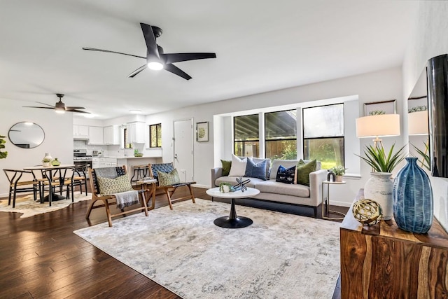 living room with dark wood-type flooring and ceiling fan