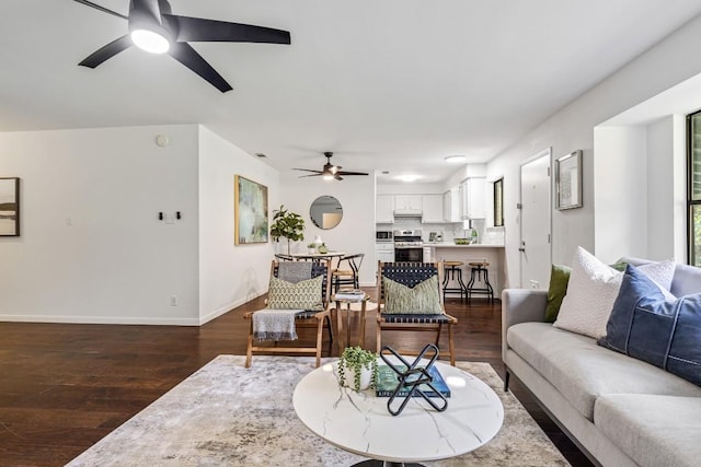 living room with dark hardwood / wood-style floors and ceiling fan