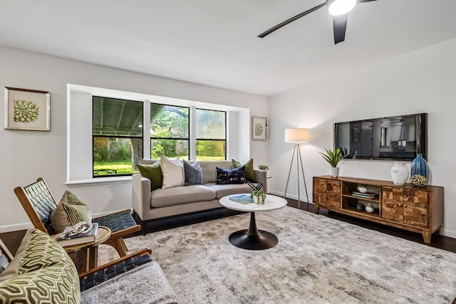 living room with wood-type flooring and ceiling fan