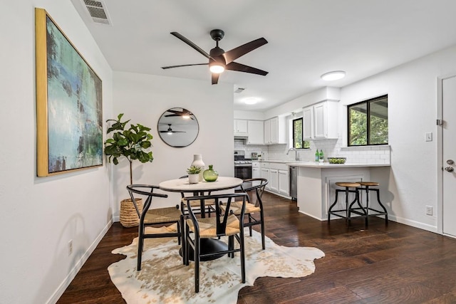 dining room featuring sink, dark hardwood / wood-style floors, and ceiling fan