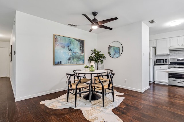 dining area with ceiling fan and dark hardwood / wood-style flooring