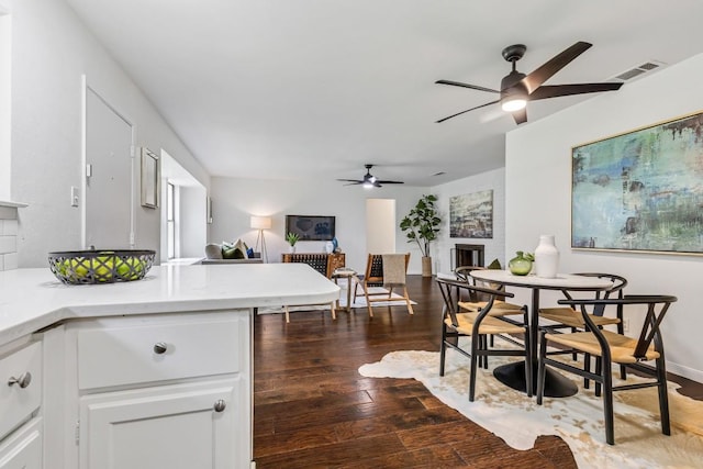 kitchen with white cabinetry, dark wood-type flooring, and ceiling fan