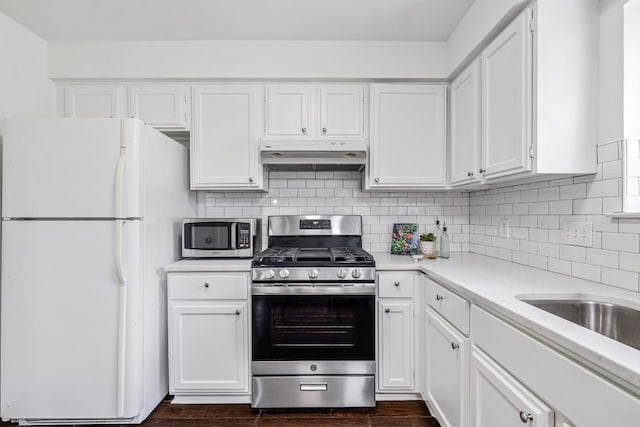 kitchen with white cabinetry, appliances with stainless steel finishes, dark hardwood / wood-style flooring, and tasteful backsplash