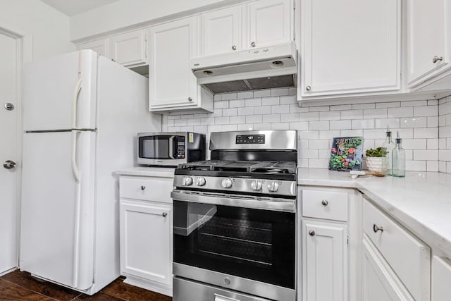 kitchen featuring tasteful backsplash, appliances with stainless steel finishes, and white cabinets