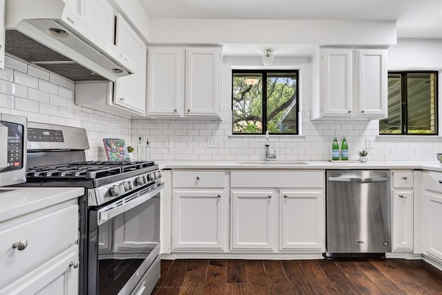 kitchen featuring dark hardwood / wood-style flooring, sink, stainless steel appliances, and white cabinets