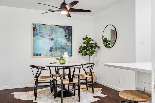 dining area featuring dark hardwood / wood-style floors and ceiling fan