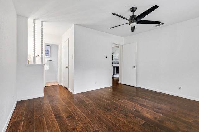 unfurnished room featuring ceiling fan and dark hardwood / wood-style flooring