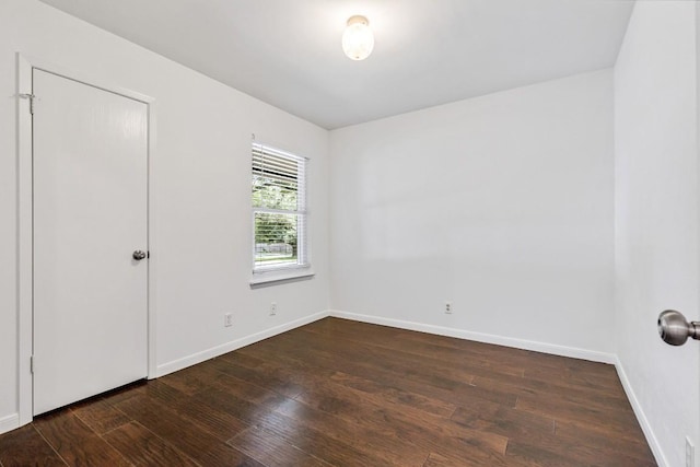 empty room with dark wood-type flooring