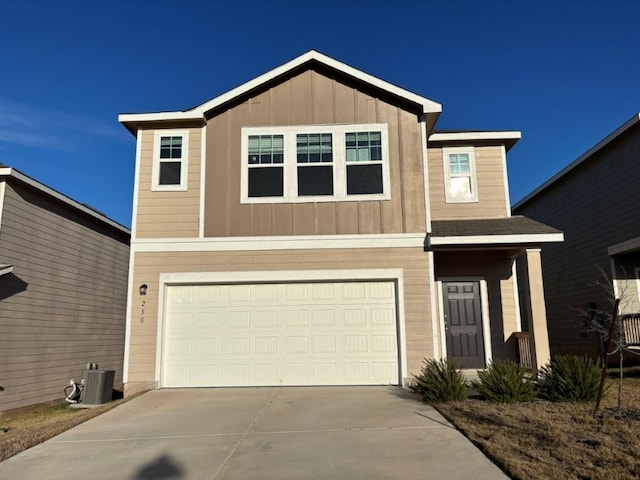 250 Night Riders Way, Jarrell, TX 76537 - view of front of property featuring an attached garage, concrete driveway, central air condition unit, and board and batten siding