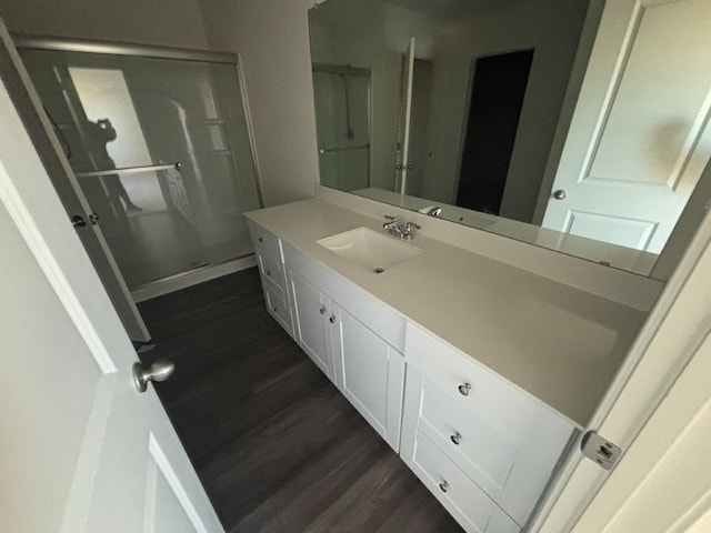 bathroom with hardwood / wood-style flooring and vanity