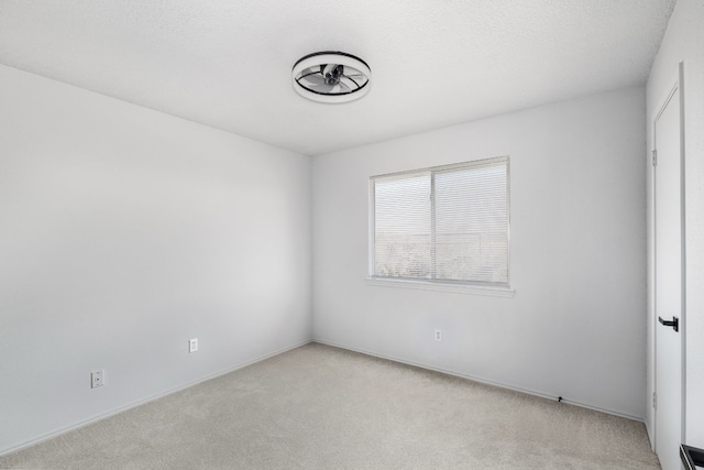 unfurnished room with light colored carpet