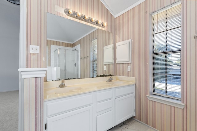 bathroom with ornamental molding, vanity, and a shower with shower door