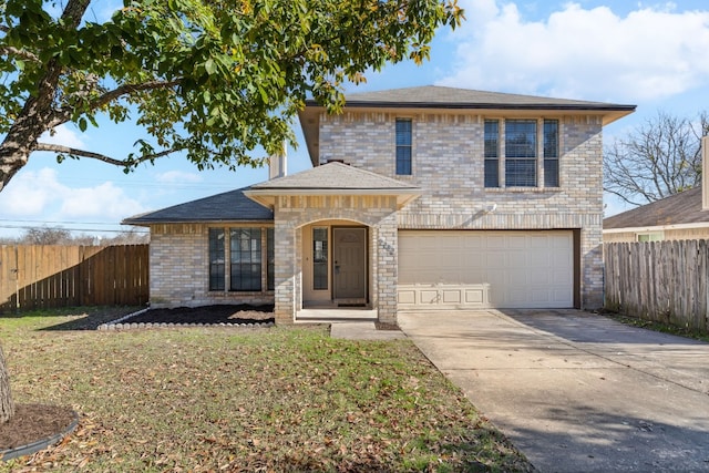 view of front of property with a garage and a front lawn