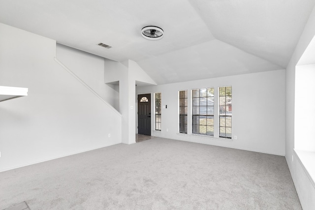 unfurnished living room featuring vaulted ceiling and carpet floors