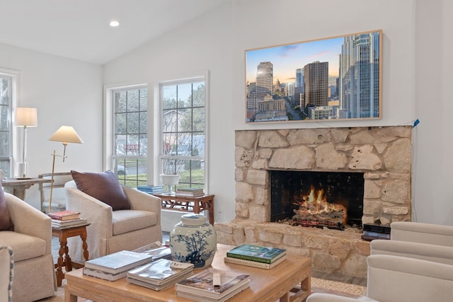 living room with lofted ceiling and a fireplace