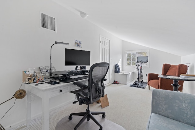 home office with light colored carpet and vaulted ceiling