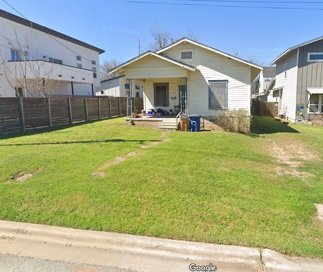 back of property featuring a porch and a lawn