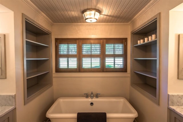 bathroom with vanity, a tub, and built in features