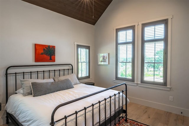 bedroom featuring hardwood / wood-style flooring and lofted ceiling