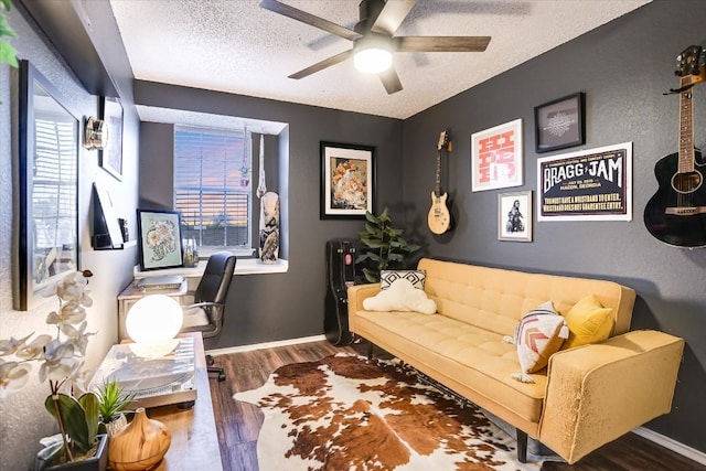 home office featuring ceiling fan, plenty of natural light, dark hardwood / wood-style floors, and a textured ceiling