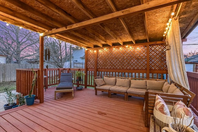 deck at dusk featuring an outdoor living space