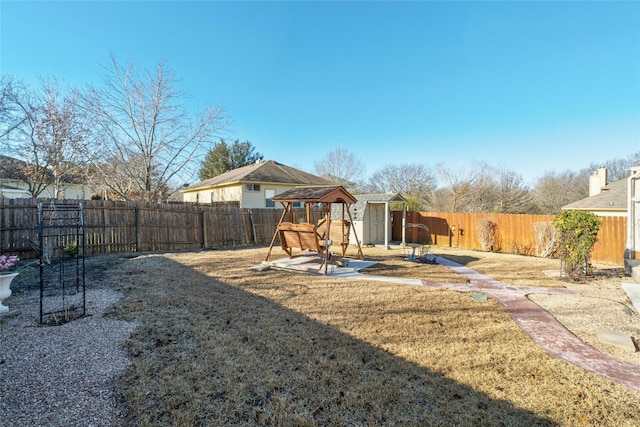 view of jungle gym with a gazebo, a yard, a patio area, and a storage unit